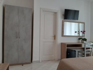 a bedroom with a closet and a mirror and a bed at Cocos Park Ischia in Ischia