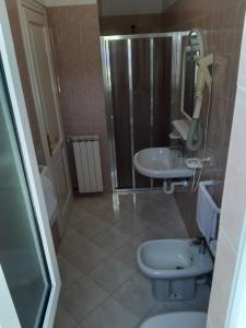 a bathroom with a toilet and a sink at Cocos Park Ischia in Ischia