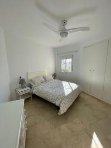 a bedroom with a bed and a ceiling fan at La Cala de Mijas Urb Alcantara in La Cala de Mijas