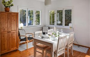 a dining room with a table and chairs and windows at Beautiful Home In Norrkping With Wifi in Norrköping