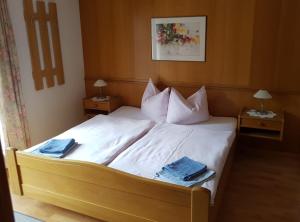 a bedroom with a large bed with two night stands at Haus Meikl in Mühlbach am Hochkönig
