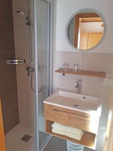 a bathroom with a sink and a shower at Haus Meikl in Mühlbach am Hochkönig