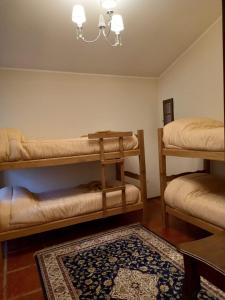 a room with two bunk beds and a rug at Casa de campo El Zoki in Villa Anizacate