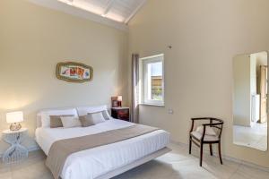 a bedroom with a bed and a chair and a window at Ciabot delle Aie - Barolo in Barolo
