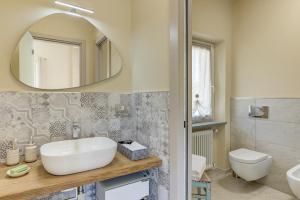 a bathroom with a sink and a mirror at Ciabot delle Aie - Barolo in Barolo