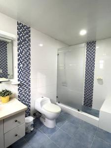 a bathroom with a toilet and a glass shower at Apartment in Dominicus in Bayahibe