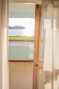 Una puerta a una habitación con vistas al agua en Sunrise at Point Village-Negril, en Negril