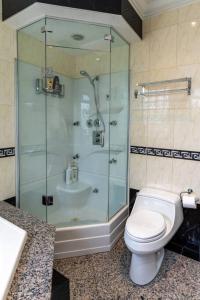 a bathroom with a toilet and a glass shower at South Vancouver home 15mins from airport/20mins from DT in Vancouver