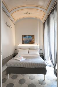 una camera con letto e soffitto a cassettoni di FINARIN Guest House a Finale Ligure