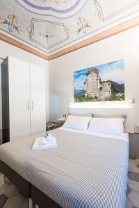 a bedroom with a bed with a painting on the ceiling at FINARIN Guest House in Finale Ligure