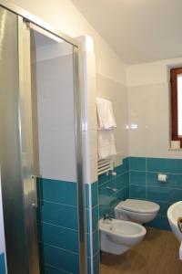 a bathroom with a toilet and a sink at Cocos Park Ischia in Ischia