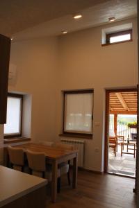 a dining room with a wooden table and chairs at G House in Dutovlje