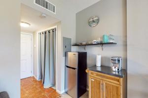 a kitchen with a stainless steel refrigerator and a counter at Pirates Bay A104 in Fort Walton Beach