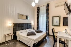 a bedroom with a large bed and a desk at Deko Rome in Rome