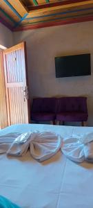 a white bed with two pillows on top of it at Cappa Cave Hotel in Göreme