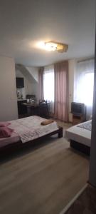 a bedroom with two beds and a television in it at Apartment Ivaylo in Varna City