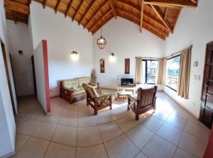 - un grand salon avec un canapé et des chaises dans l'établissement Complejo Cabañas del Jaguel, à Santa Teresita