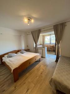 a bedroom with two beds and a dining room at Guesthouse Hodak in Seliste Dreznicko