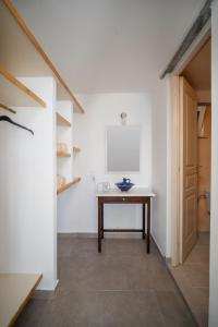 a room with a wooden table in the middle of a room at Alcyone in Serifos Chora