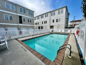 a swimming pool in front of a building at Beach Block 4 Bedroom with POOL in North Wildwood