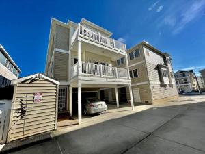 a house with a car parked in front of it at Beach Block 4 Bedroom with POOL in North Wildwood