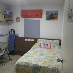 a bedroom with a bed with a dresser and a window at DEPARTAMENTO BREÑA POR Hospital LOAYZA in Lima