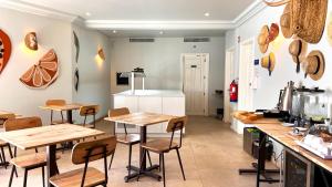 - une cuisine avec des tables et des chaises en bois dans la chambre dans l'établissement Jardim da Lapa by Shiadu, à Lisbonne