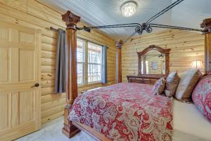 a bedroom with a bed in a room with wooden walls at Cliffside Eureka Springs Cabin with Beaver Lake View in Eureka Springs