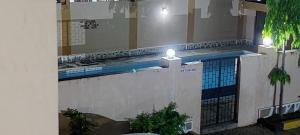 a building with a swimming pool with two lights on it at Betty Homes in Mombasa