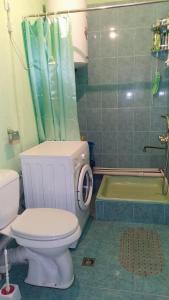 a bathroom with a toilet and a shower and a tub at Syunyats guest house in Halidzor