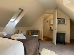 a bedroom with a bed in a attic at Crofts Mill in Ballater