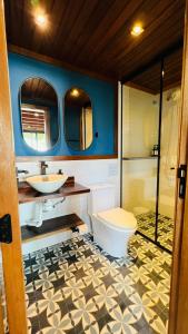 a bathroom with a toilet and a sink and a shower at Ilha do Mel Lodges in Ilha do Mel