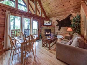 a living room with a couch and a table and a fireplace at Cub’s Cove, 1 Bedroom, Near Downtown, View, Jetted Tub, WiFi, Sleeps 4 in Gatlinburg