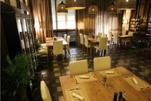 a dining room with tables and chairs in a restaurant at Hotel Kirov in Kirov