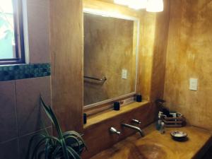 a bathroom with a sink and a large mirror at Maria Del Alma House in Mexico City +92 photos