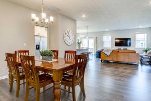 a dining room and living room with a table and chairs at Spacious Home with Patio Near Fishers! in Fishers