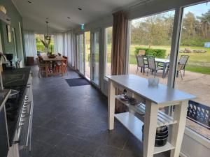 una cucina e una sala da pranzo con tavolo e sedie di Boshoes a Heythuysen