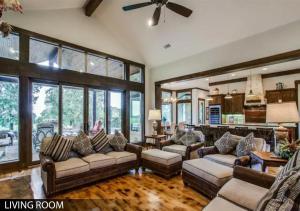 a living room with couches and a living room with windows at Hilltop Ranch House - Holiday & Family Destination in Valley View