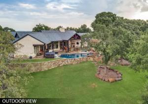 an aerial view of a house with a swimming pool at Hilltop Ranch House - Holiday & Family Destination in Valley View