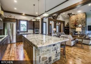 a large kitchen and living room with a large island at Hilltop Ranch House - Holiday & Family Destination in Valley View