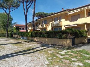 a building with a fence and trees in front of it at L'Orchidea_Holiday in Camaiore