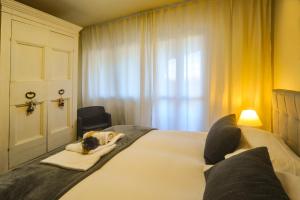 a bedroom with a large white bed in front of a window at Lake View 30 in Sulzano