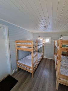 a room with two bunk beds in a house at Camp Saltstraumen-Elvegård in Bodø
