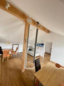 a living room with a table and a bedroom at Sonnenterrasse in Weilheim in Oberbayern