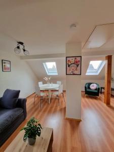 a living room with a couch and a table at Feel-good apartment close to the city in Reppenstedt