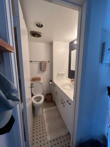 a small bathroom with a toilet and a sink at Ocean view in Vancouver