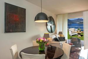 a living room with a table with flowers on it at Lake View 30 in Sulzano