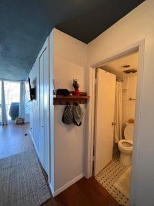 a bathroom with a toilet and a hallway at Ocean view in Vancouver