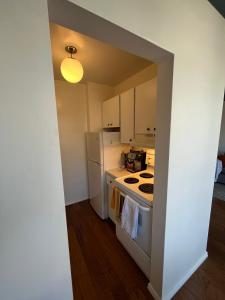 a small kitchen with a stove and a refrigerator at Ocean view in Vancouver