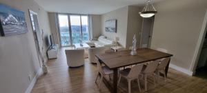a dining room and living room with a table and chairs at NEW LUXURY APARTMENT 2Br 2Ba DIRECT BEACH ACCESS in Hollywood
